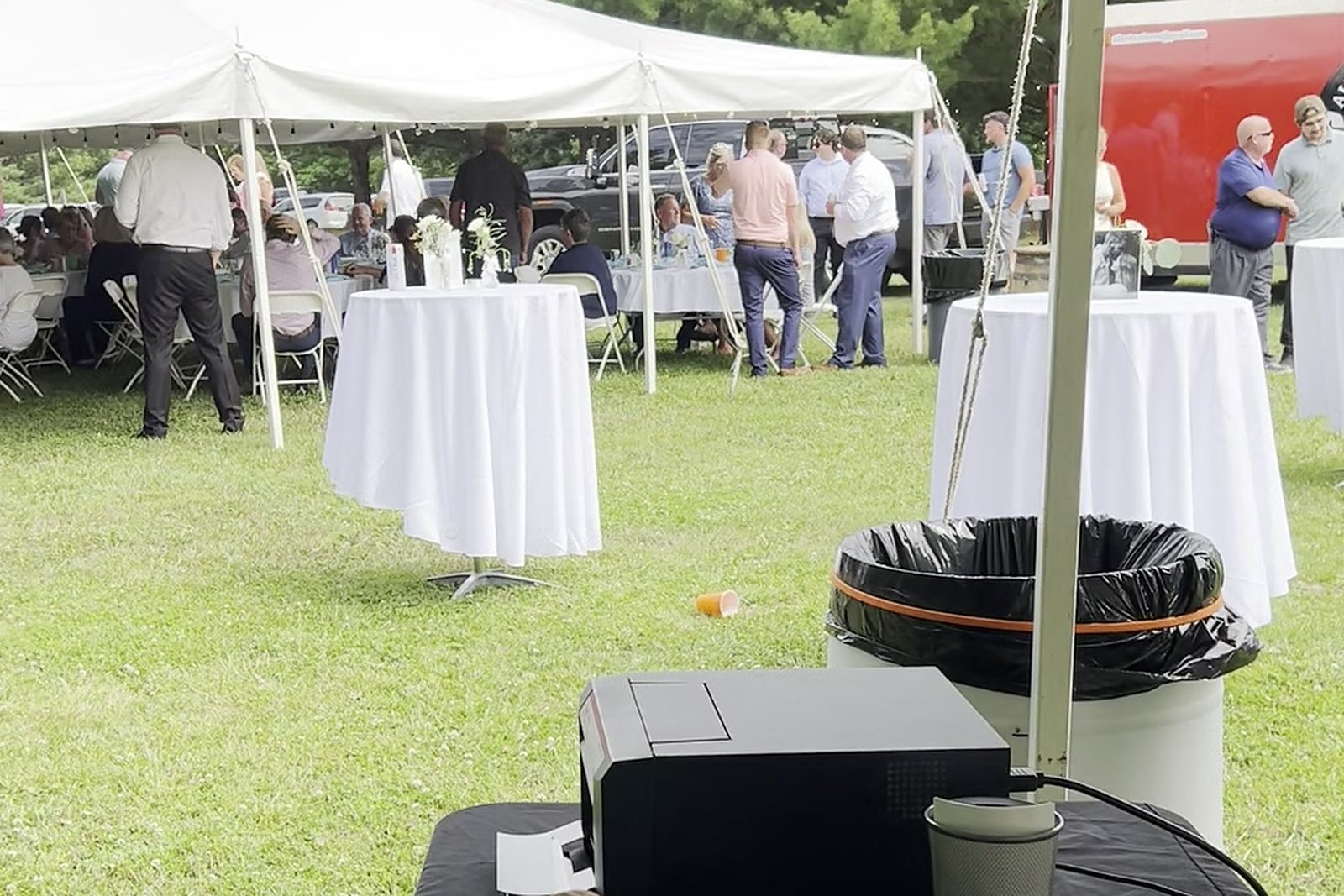 Outdoor backyard graduation party with photo booth tent setup
